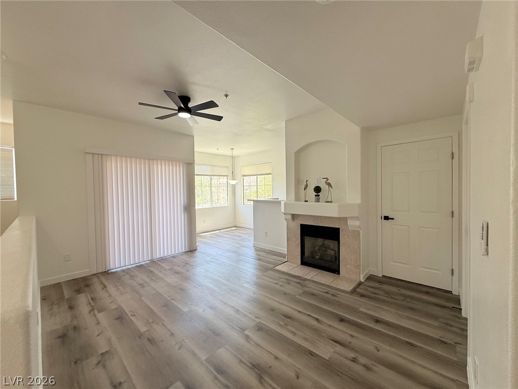 9050 West Warm Springs Road, Unit 2002 Las Vegas, NV 89148 - Photo 11 of 46 This airy living space features a cozy fireplace and modern flooring, perfect for comfortable living.
