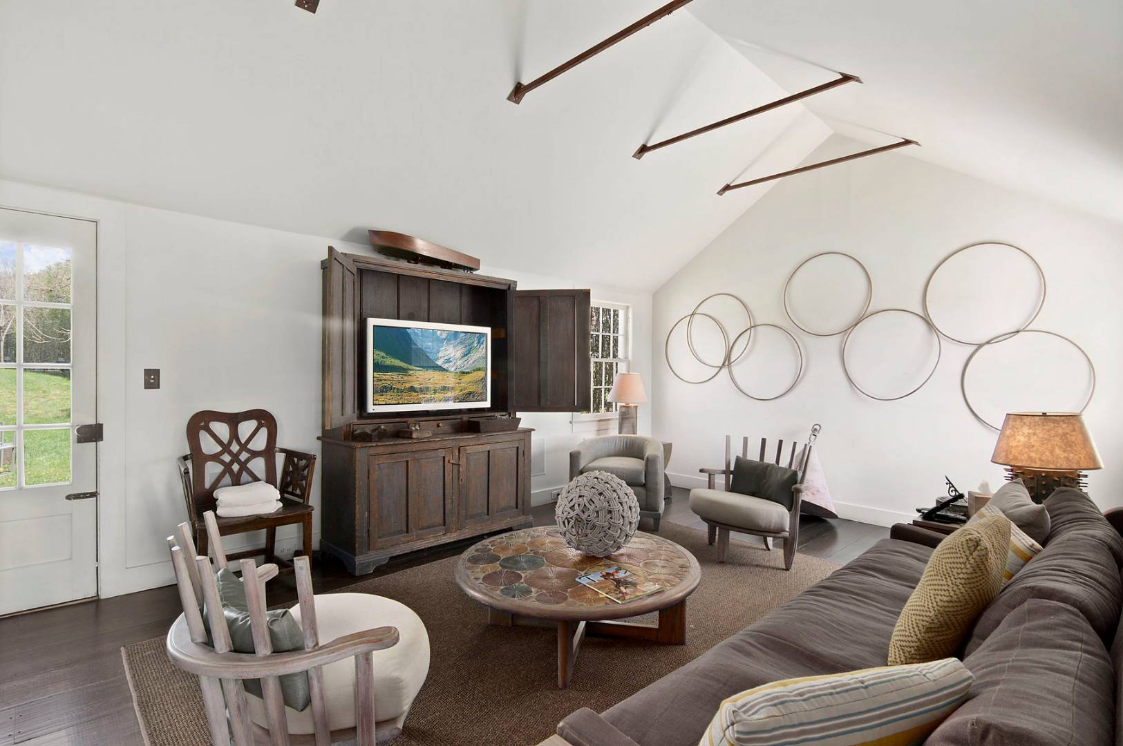 56 Sagaponack Road Bridgehampton, NY 11932 - Photo 3 of 15 a living room with furniture a rug and a flat screen tv