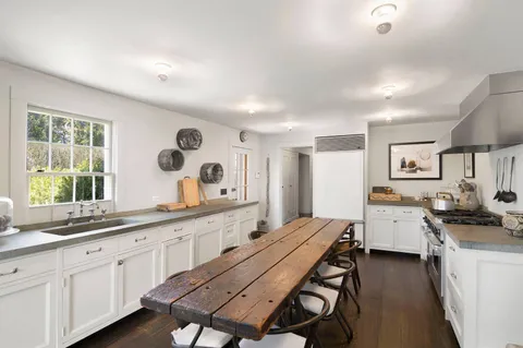 a large kitchen with a table and chairs in it