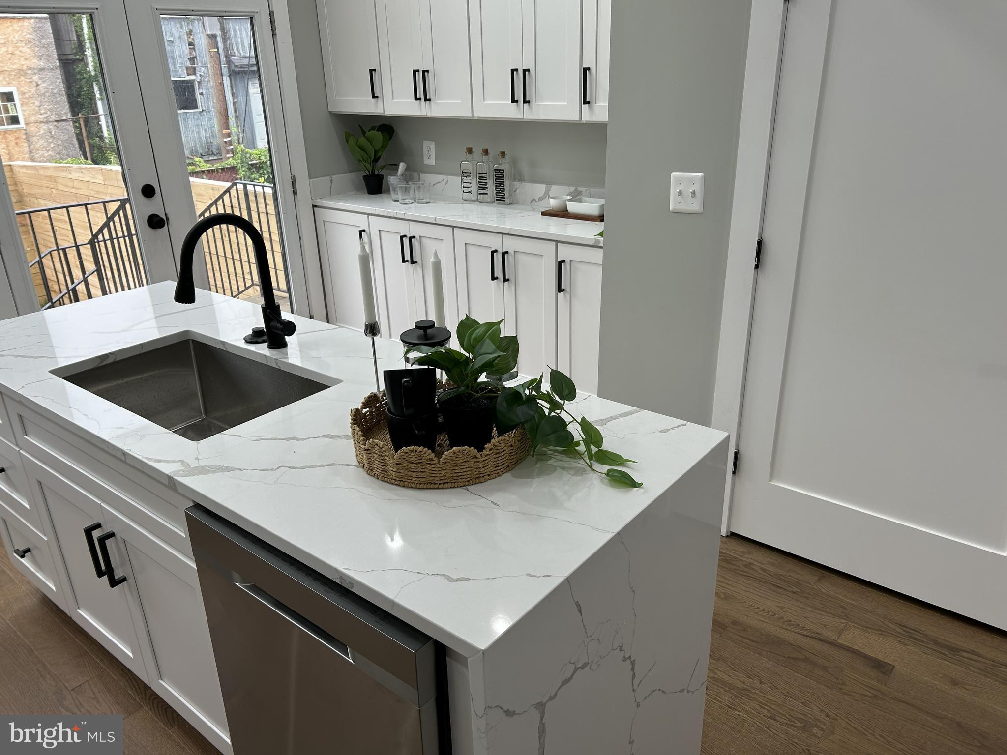 928 Perry Place Northeast Washington, DC 20017 - Photo 6 of 16 a kitchen with a sink a microwave and cabinets