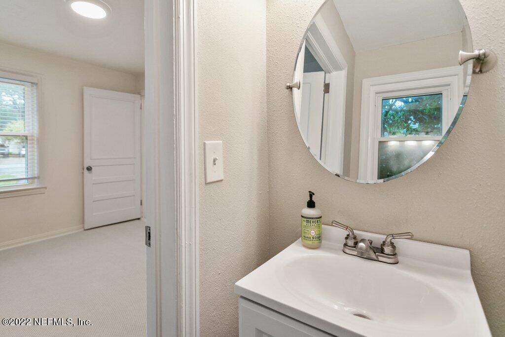 1499 Birmingham Road South Jacksonville, FL 32207 - Photo 38 of 51 a bathroom with a sink and a mirror