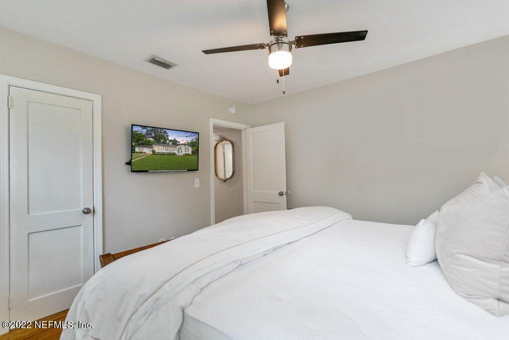 1499 Birmingham Road South Jacksonville, FL 32207 - Photo 10 of 51 a bedroom with a bed and a chandelier