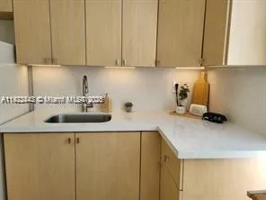 a kitchen with a sink and cabinets