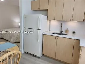 a kitchen with a refrigerator and cabinets