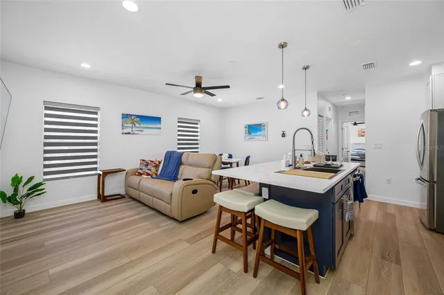 a living room with furniture and kitchen view