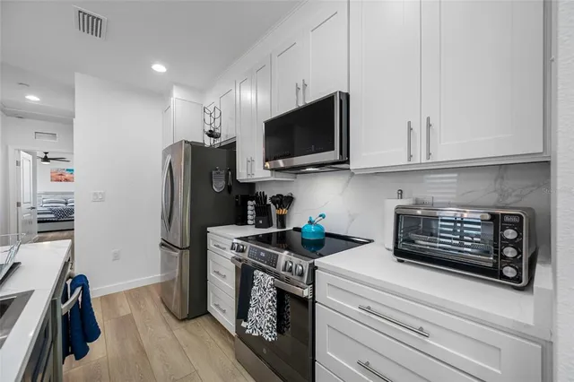 a bedroom with a bed and a ceiling fan