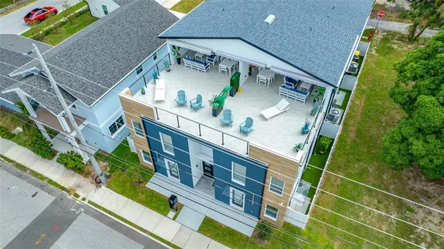 a view of a white house with a yard