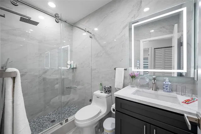 a bathroom with a sink toilet and mirror