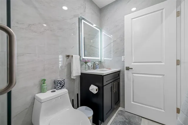 a bathroom with a sink toilet a mirror and shower