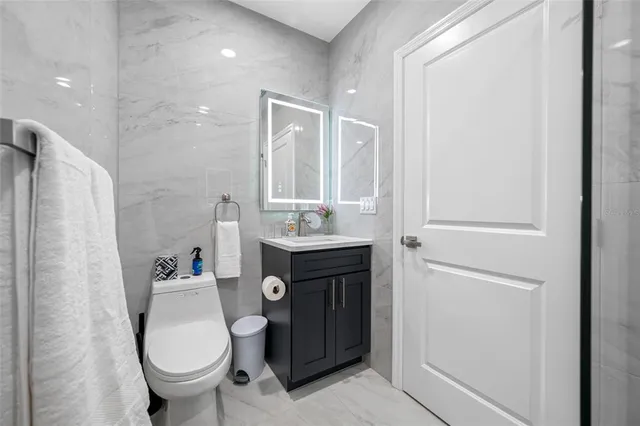 a bedroom with a balcony a bed and a chandelier