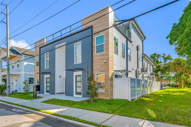 an aerial view of residential building with outdoor space and lake view