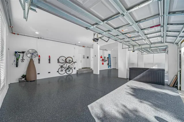 an aerial view of a house with swimming pool and large trees