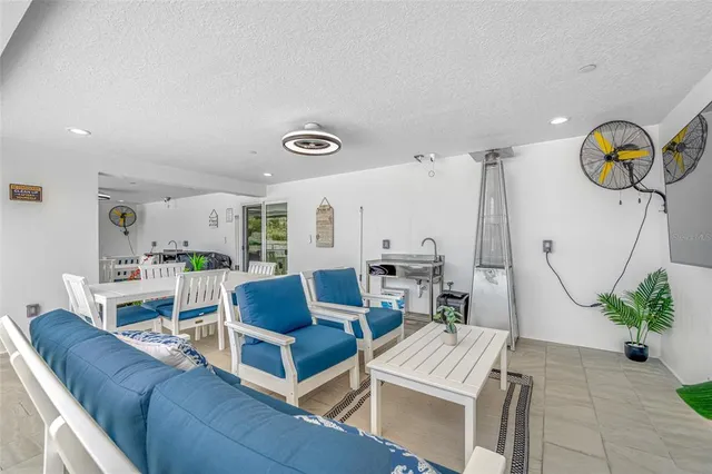 a view of a dining room with furniture and a large window