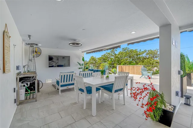 a view of a chair and tables in the patio