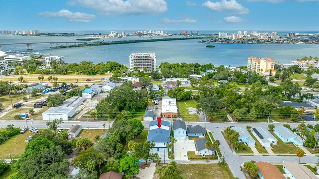 a backyard of a house with a fountain and plants