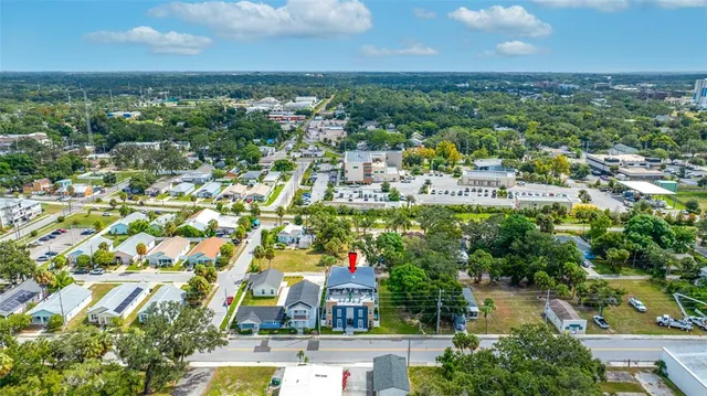 a view of a livingroom with wooden floor and stairs