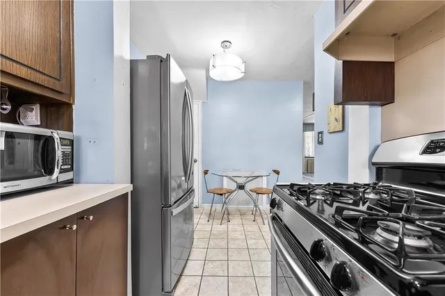 a kitchen with stainless steel appliances granite countertop a stove and a refrigerator