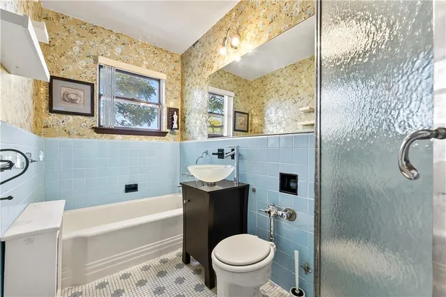 a bathroom with a sink toilet and shower