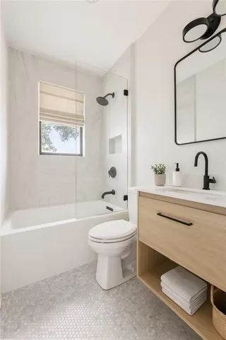 a bathroom with a sink a toilet and a bathtub