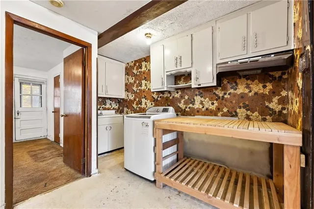 a kitchen with refrigerator and cabinets