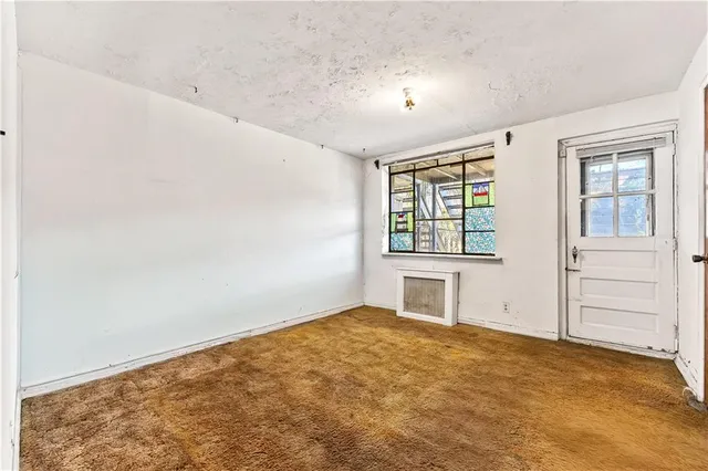 a view of a big room with windows and closet