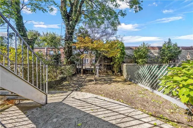 a view of a patio with couches table and chairs and potted plants