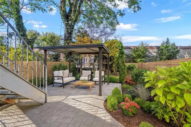 a view of a porch with a table and chairs
