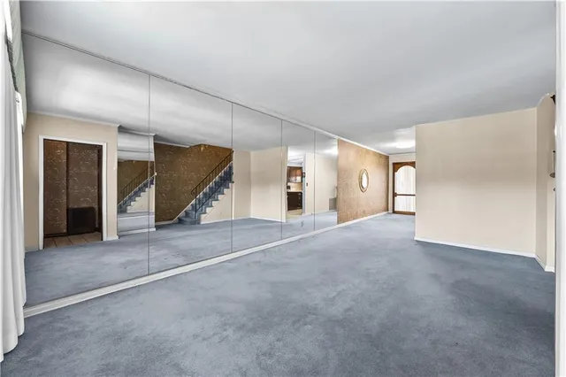 a view of a livingroom with an empty space and garage
