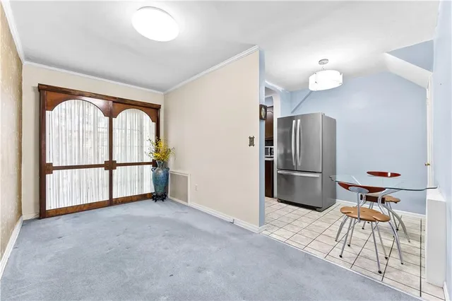 a very nice looking room with a large window and stainless steel appliances