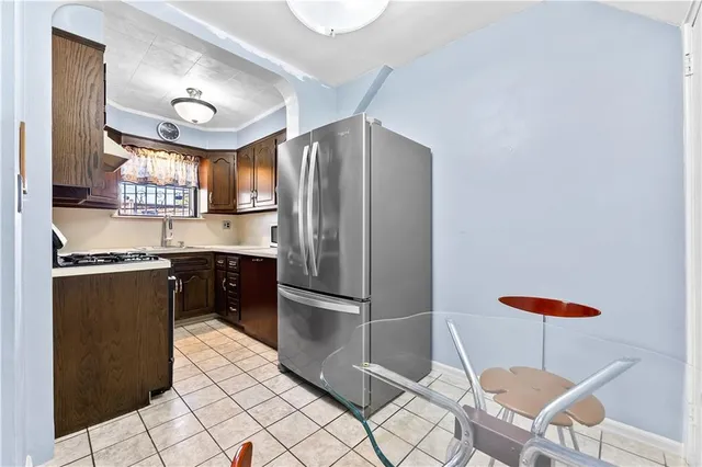 a kitchen with stainless steel appliances granite countertop a refrigerator and a stove top oven