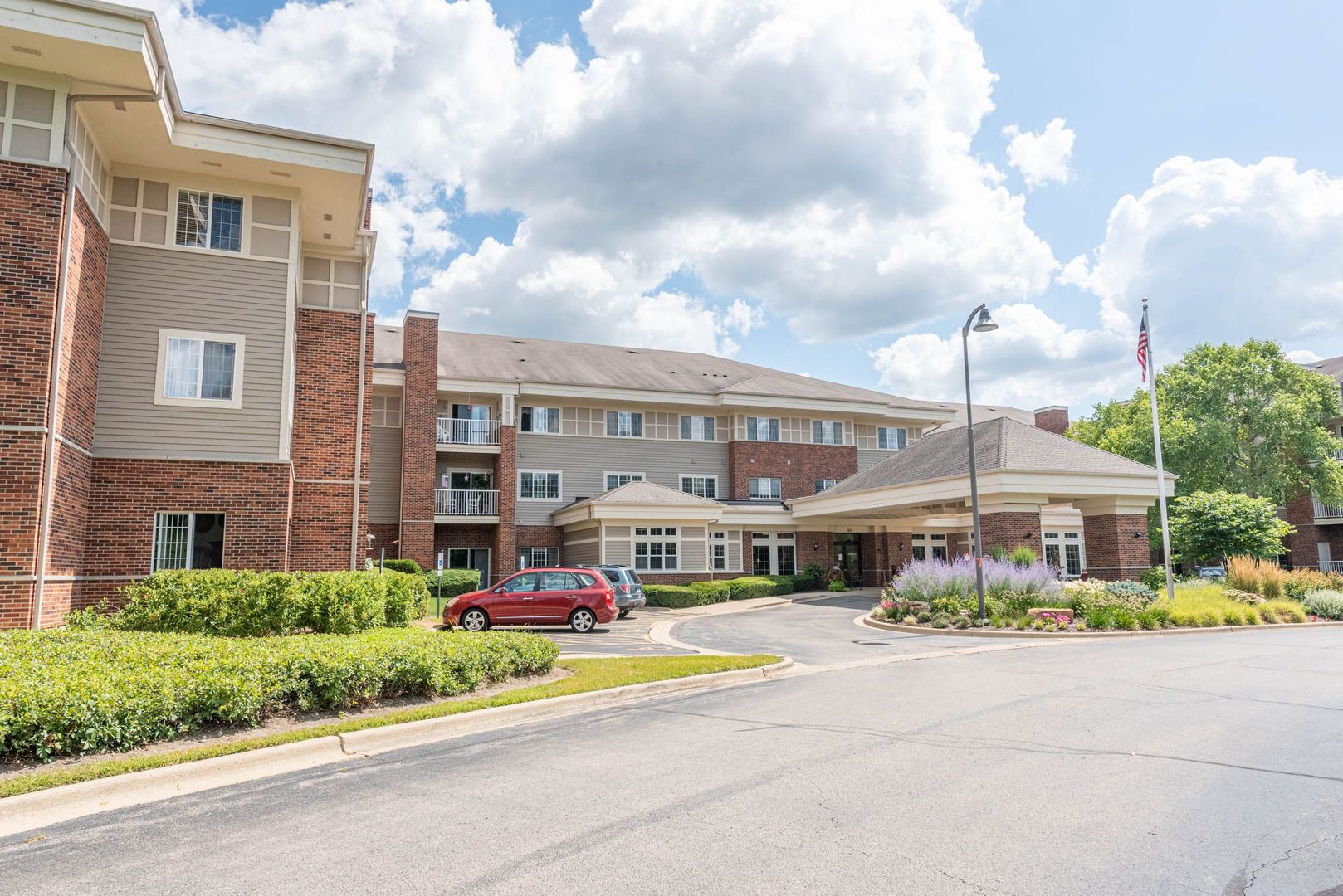 801 North McLean Boulevard, Unit 300 Elgin, IL 60123 - Photo 15 of 16 a front view of building with small garden and entertaining space