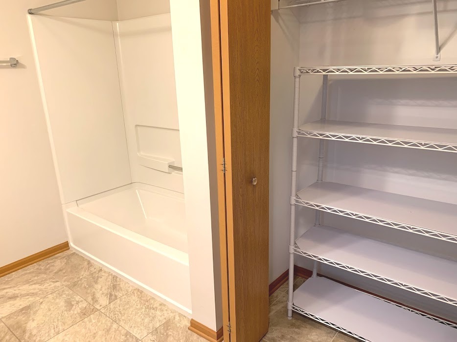 801 North McLean Boulevard, Unit 300 Elgin, IL 60123 - Photo 9 of 16 a bathroom with a tub and shower