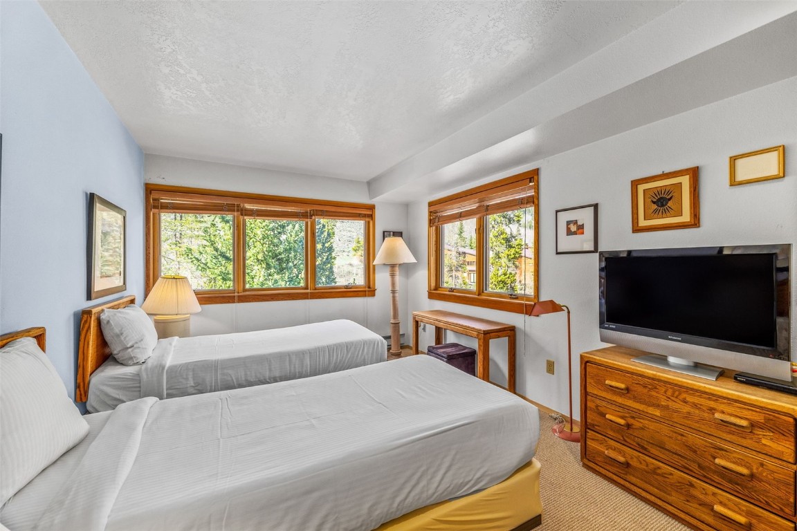 240 Tennis Club Road, Unit 1677 Keystone, CO 80435 - Photo 32 of 46 Carpeted bedroom with multiple windows and a textured ceiling