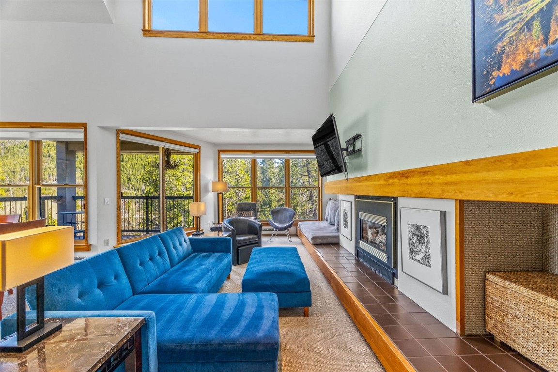 240 Tennis Club Road, Unit 1677 Keystone, CO 80435 - Photo 5 of 46 Tiled living room with a fireplace and a high ceiling