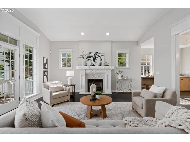 a living room with furniture a fireplace and a table