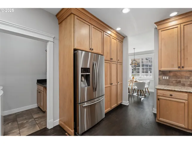 a kitchen with stainless steel appliances granite countertop a refrigerator and a stove top oven