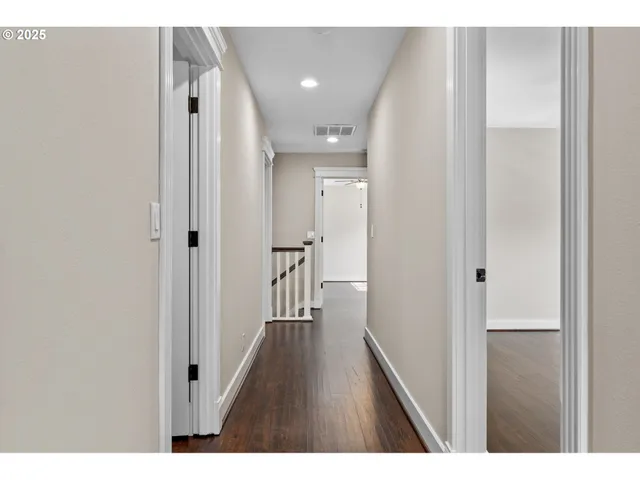 a view of hallway with wooden floor