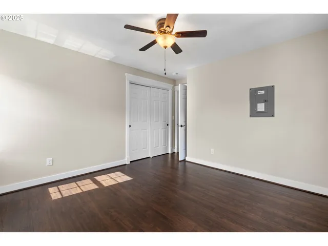 a view of an empty room with wooden floor