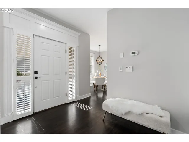 a view of a hallway with wooden floor and closet