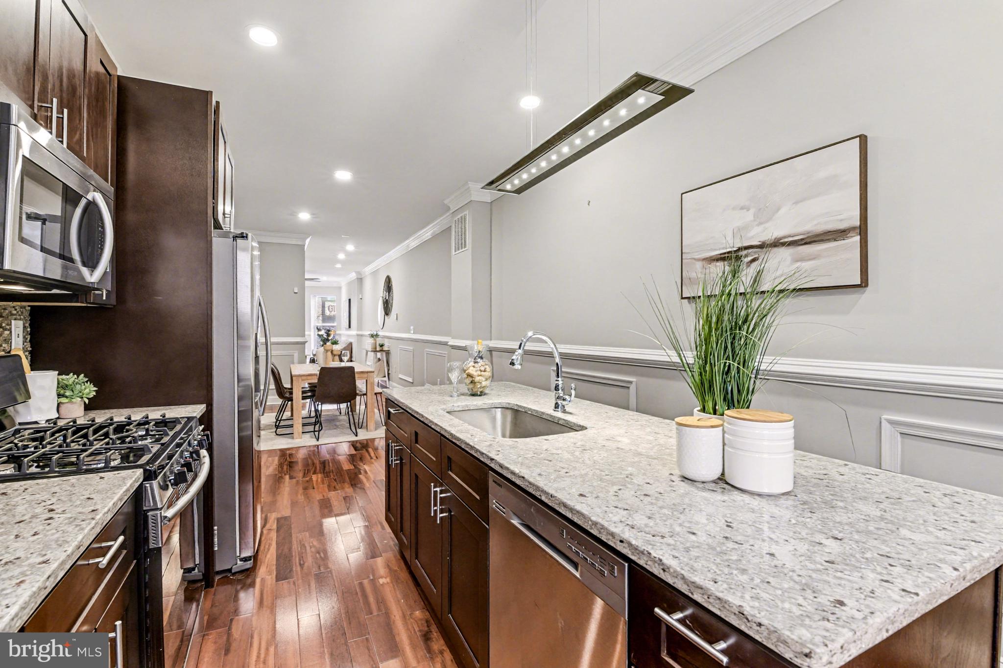 1431 Madison Avenue Baltimore, MD 21217 - Photo 13 of 38 a kitchen with a counter top space a sink and appliances