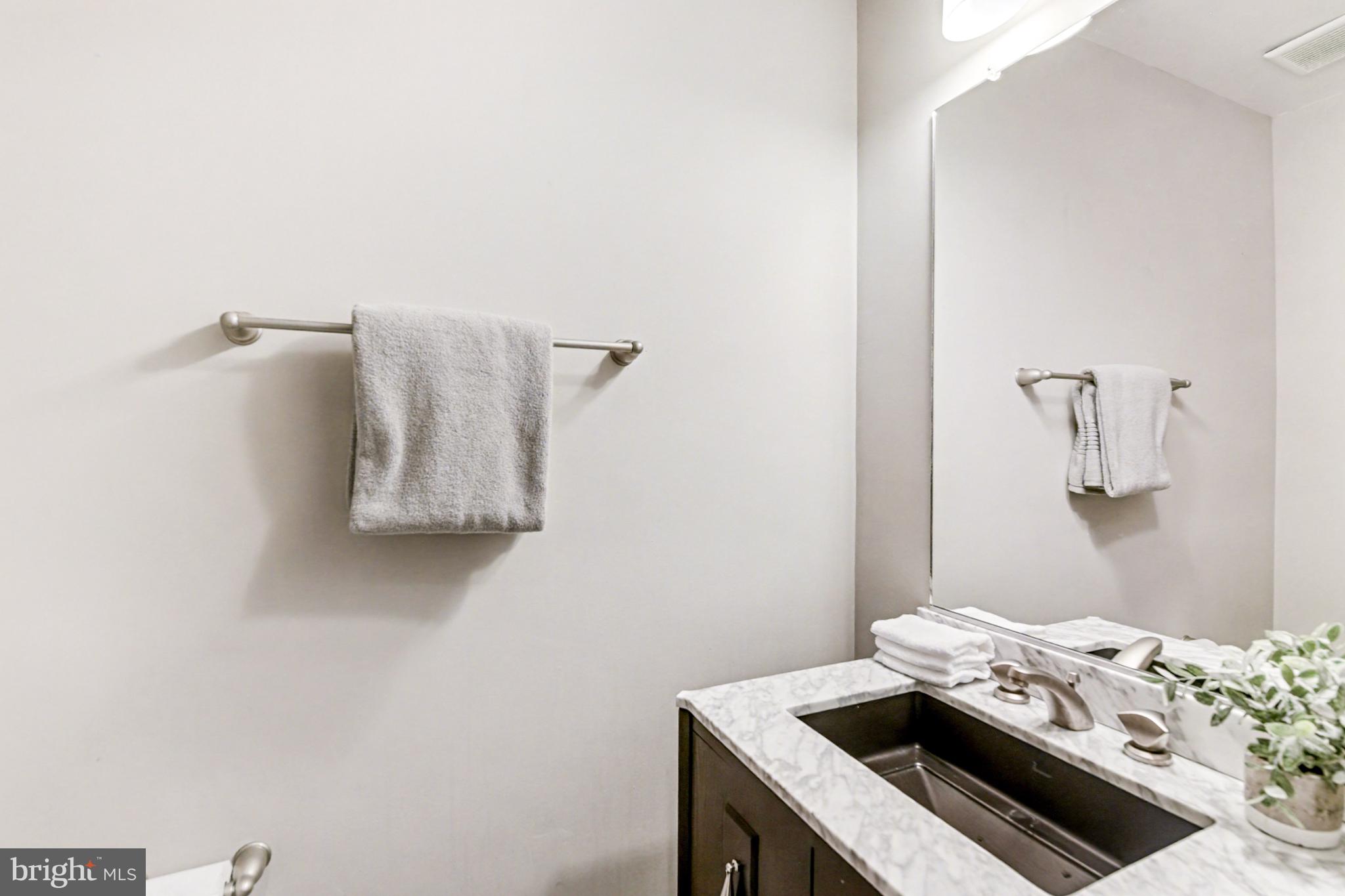 1431 Madison Avenue Baltimore, MD 21217 - Photo 14 of 38 a bedroom with a bed and a table in it