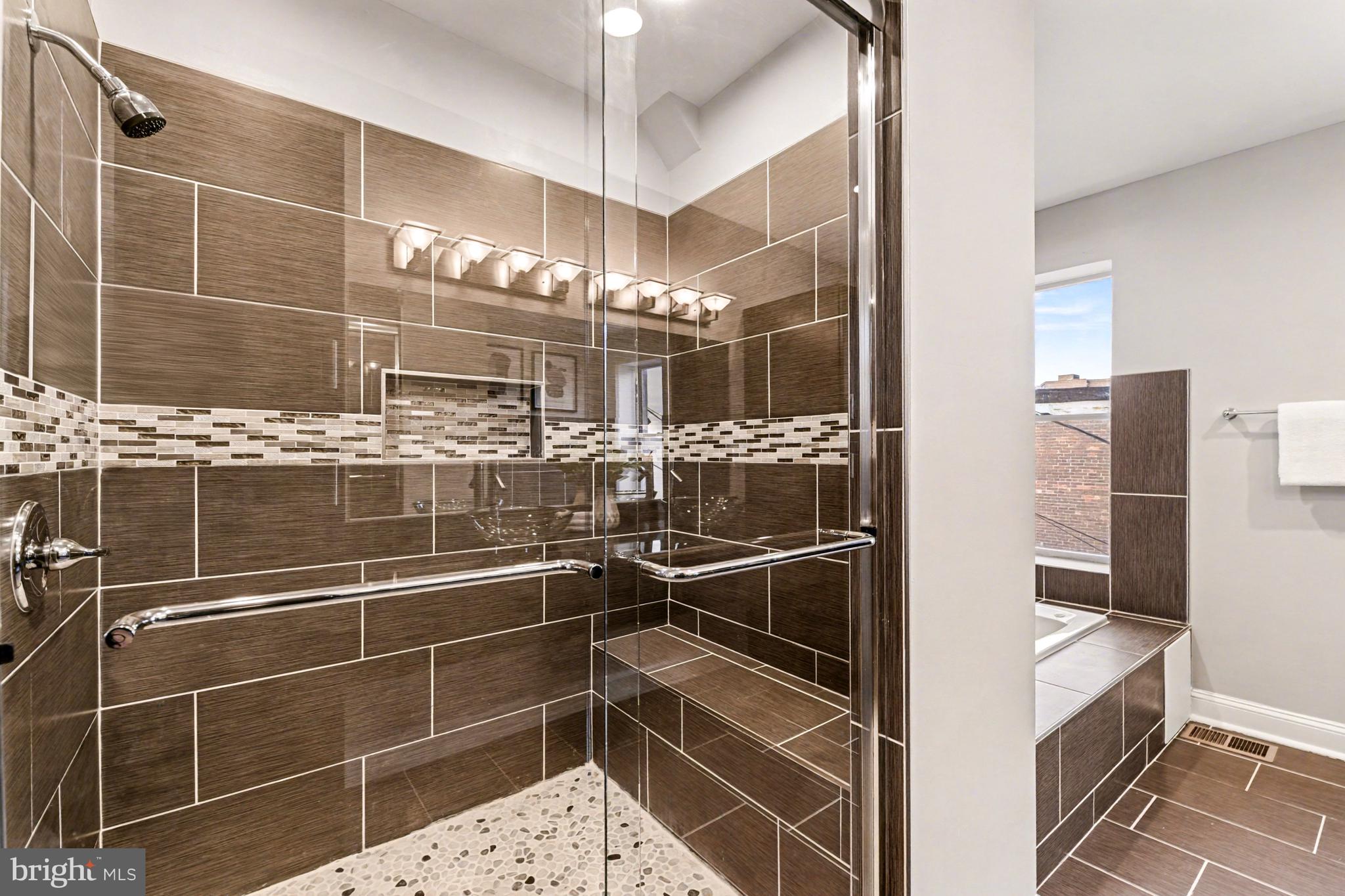 1431 Madison Avenue Baltimore, MD 21217 - Photo 15 of 38 a bathroom with a glass shower door and a sink
