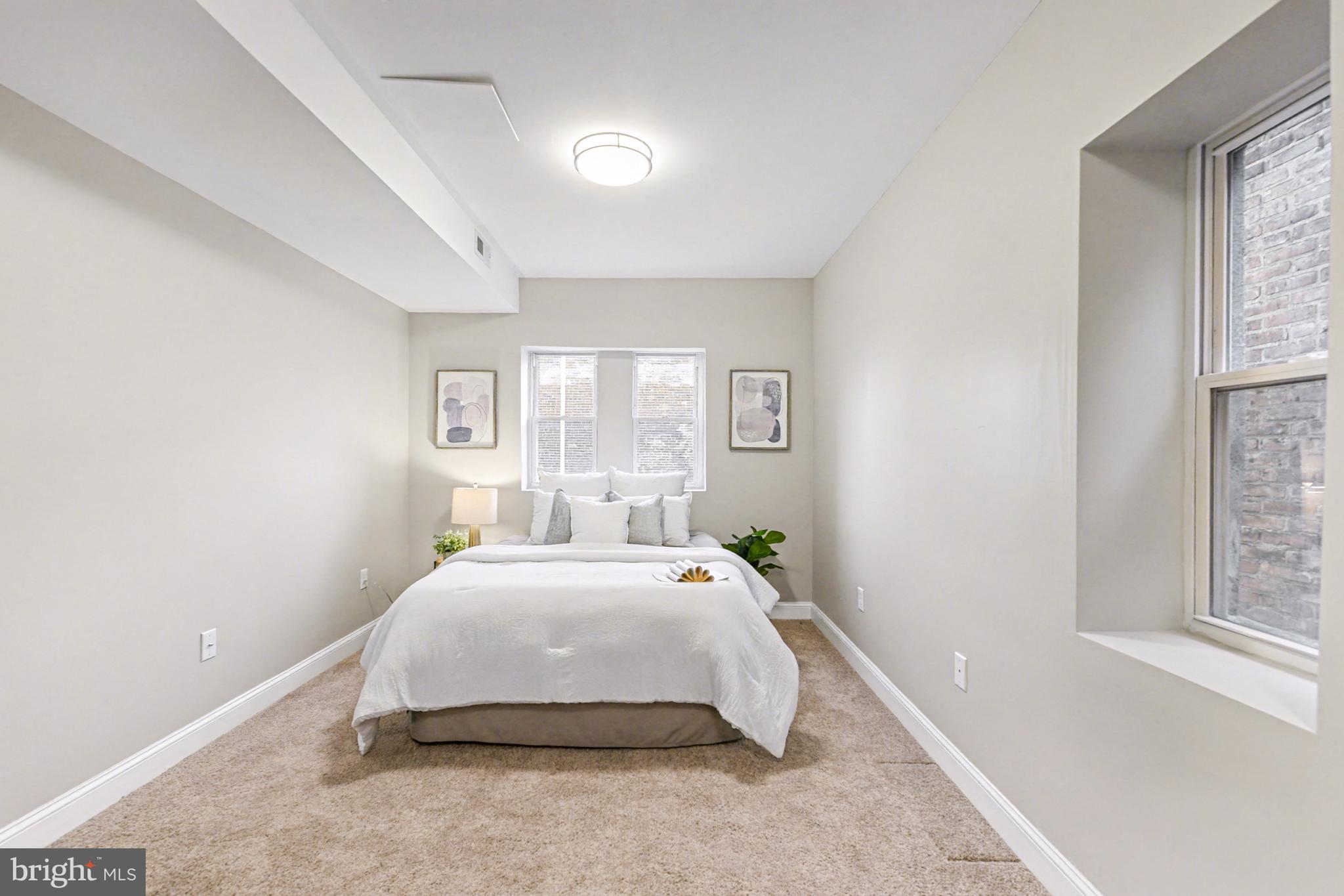 1431 Madison Avenue Baltimore, MD 21217 - Photo 16 of 38 a spacious bedroom with a bed and a window
