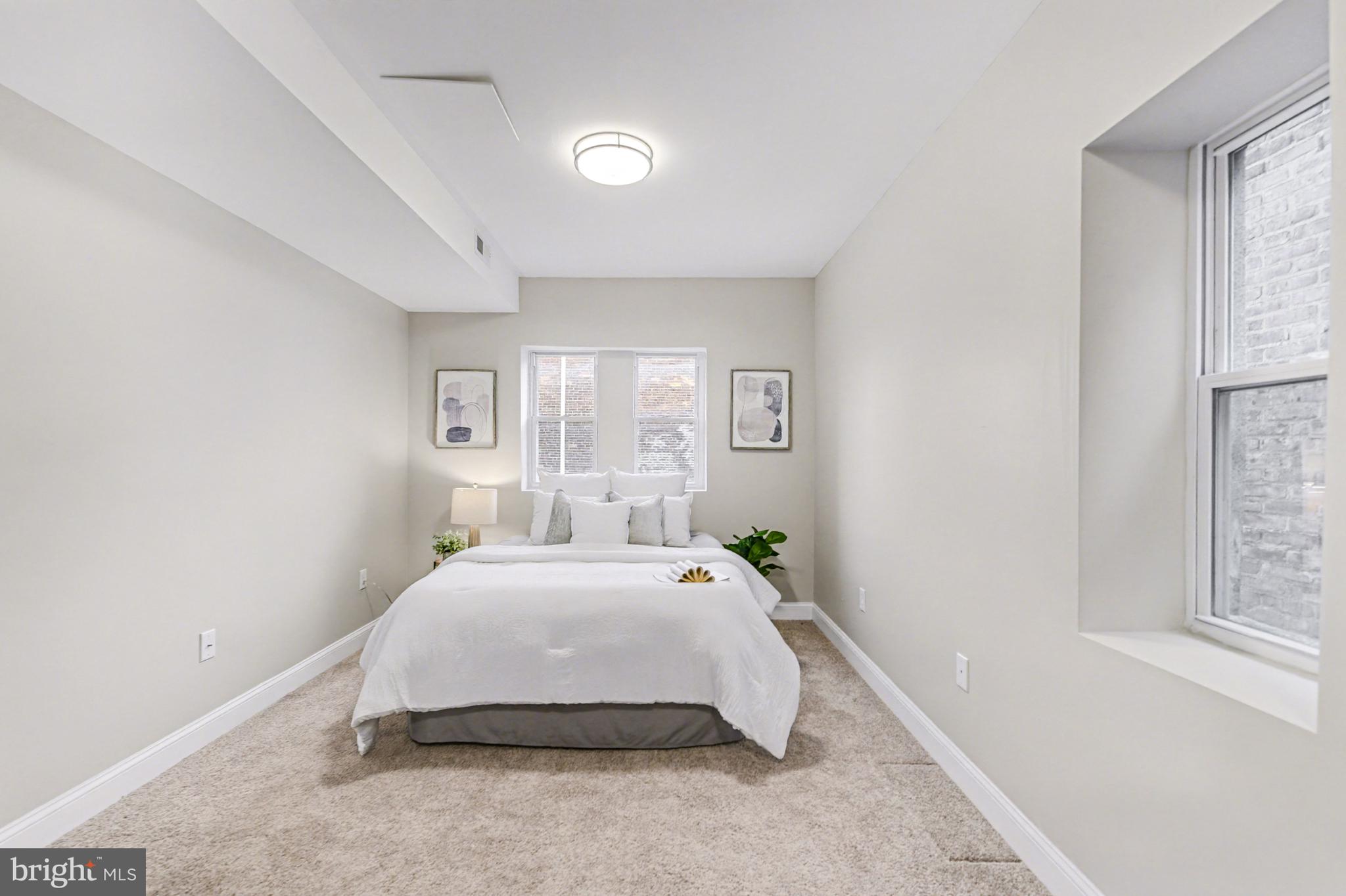 1431 Madison Avenue Baltimore, MD 21217 - Photo 17 of 38 a spacious bedroom with a bed and window