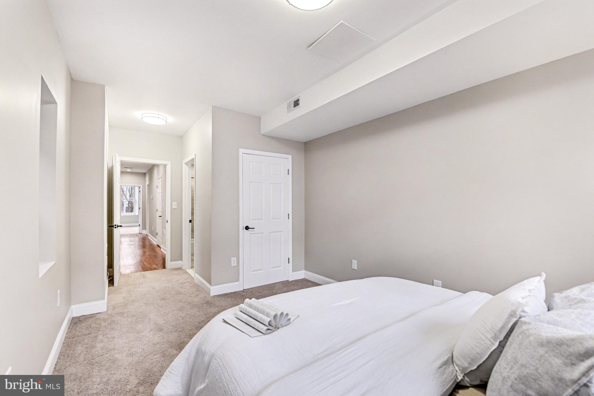 1431 Madison Avenue Baltimore, MD 21217 - Photo 18 of 38 a bedroom with a bed and a view of bathroom