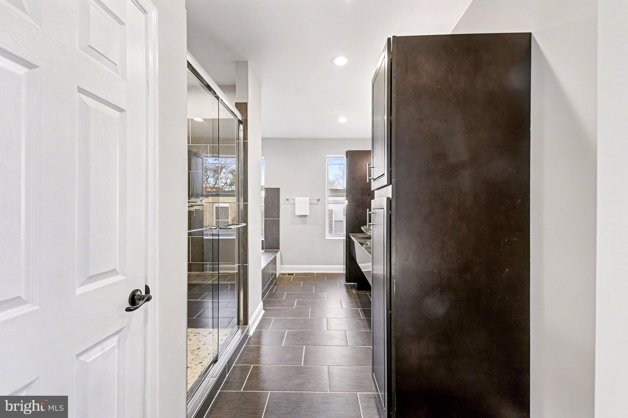 1431 Madison Avenue Baltimore, MD 21217 - Photo 26 of 38 a bathroom with a glass shower door