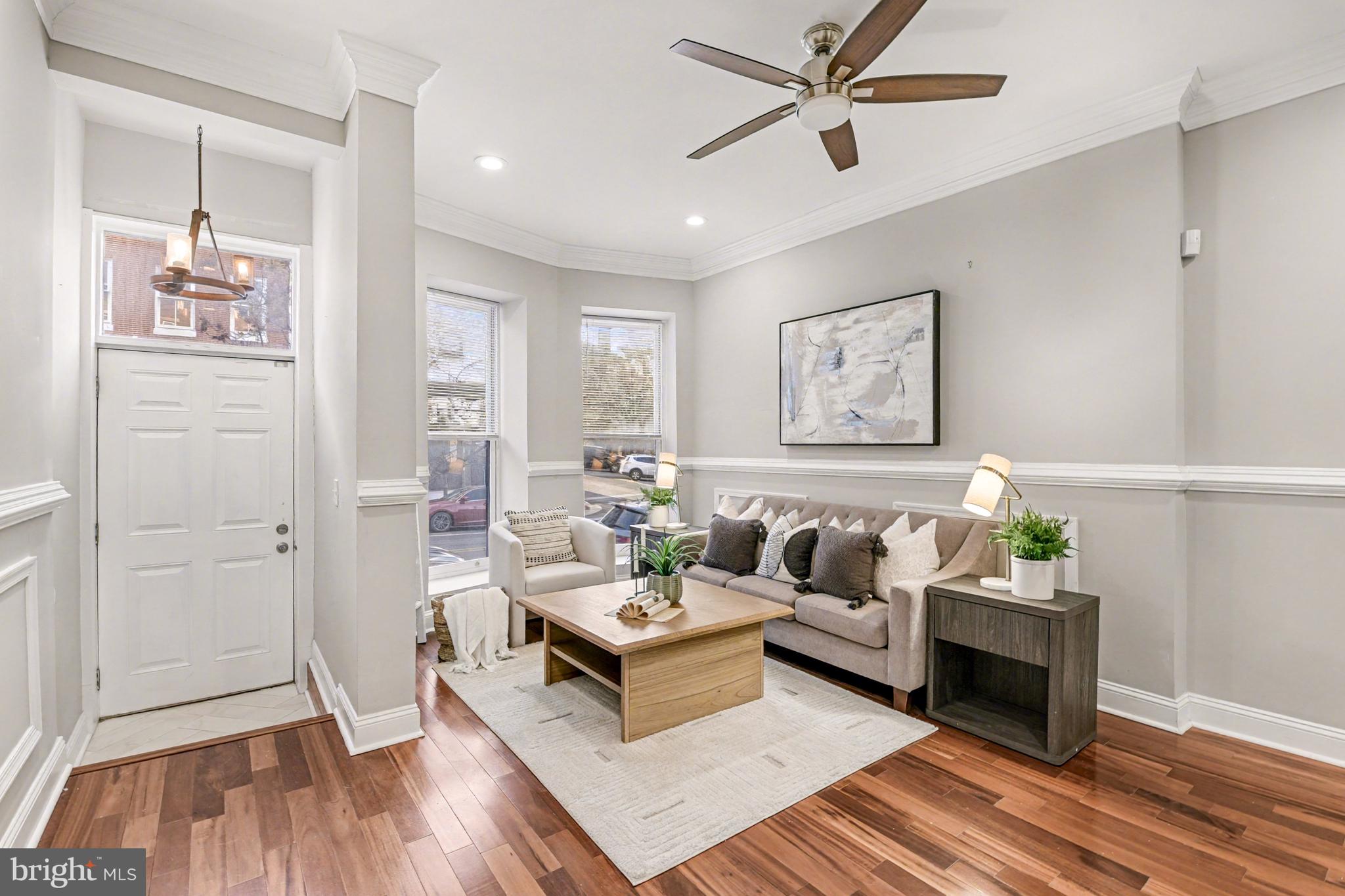 1431 Madison Avenue Baltimore, MD 21217 - Photo 3 of 38 a living room with furniture and a wooden floor
