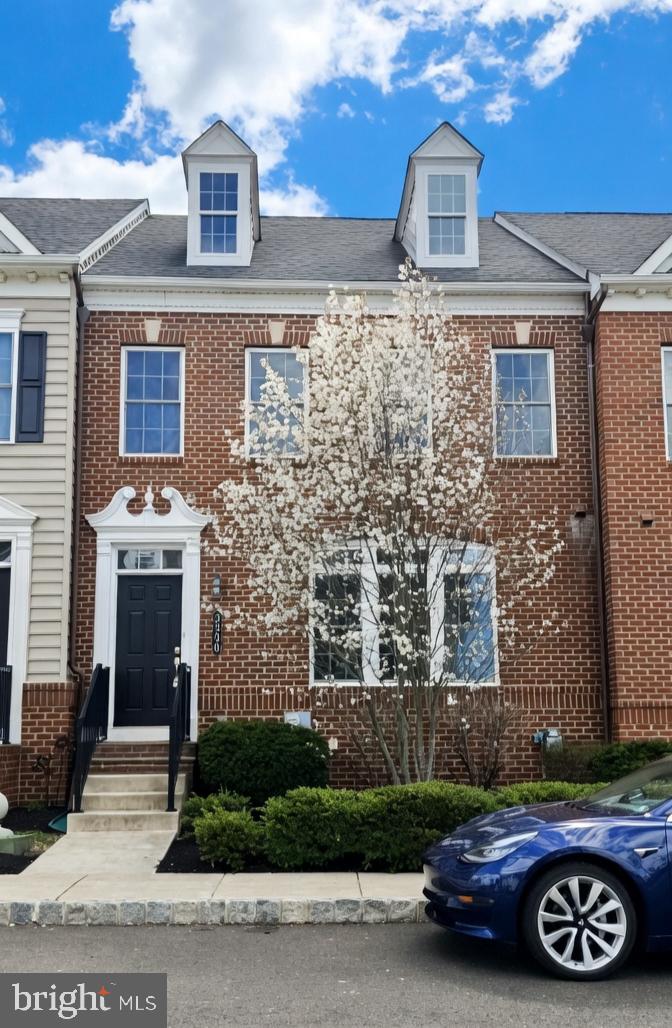 a front view of a house with parking space