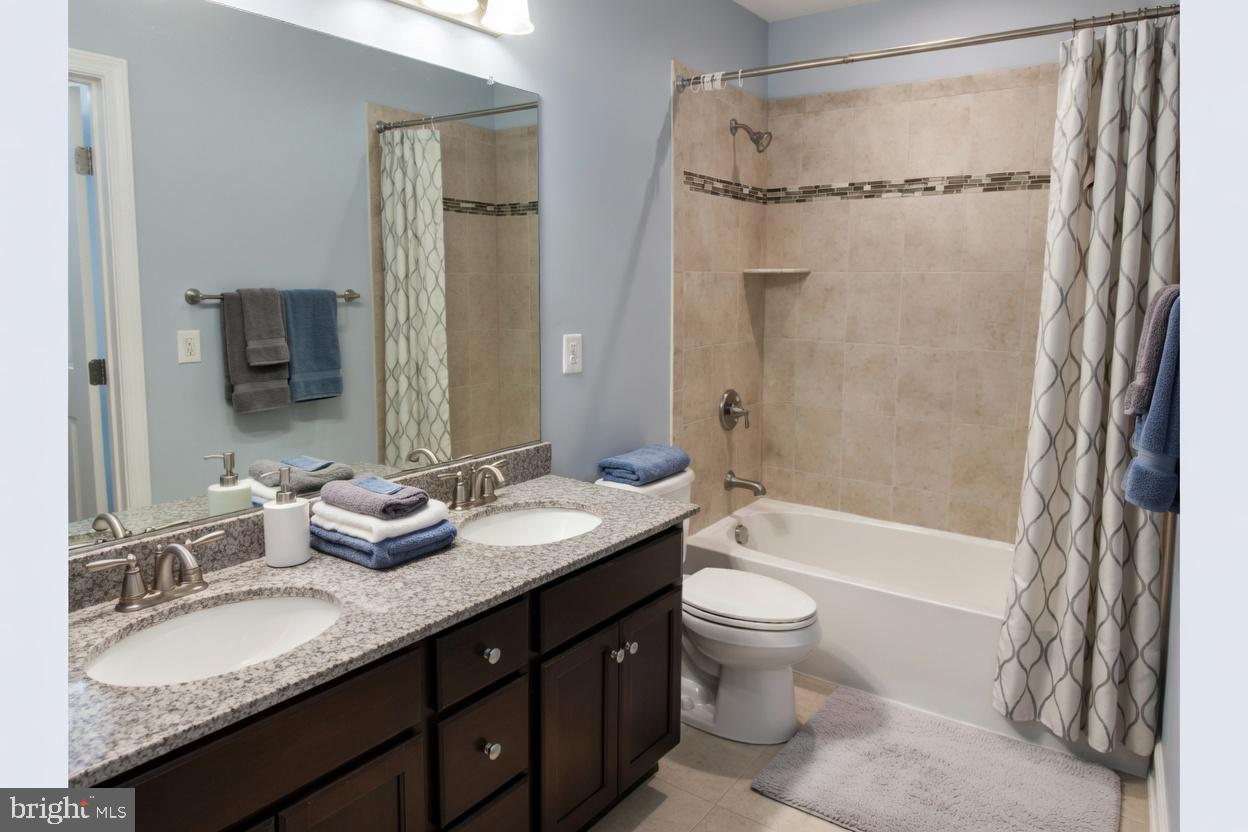 3990 Cephas Child Road Doylestown, PA 18902 - Photo 37 of 53 a bathroom with a granite countertop sink toilet mirror and shower