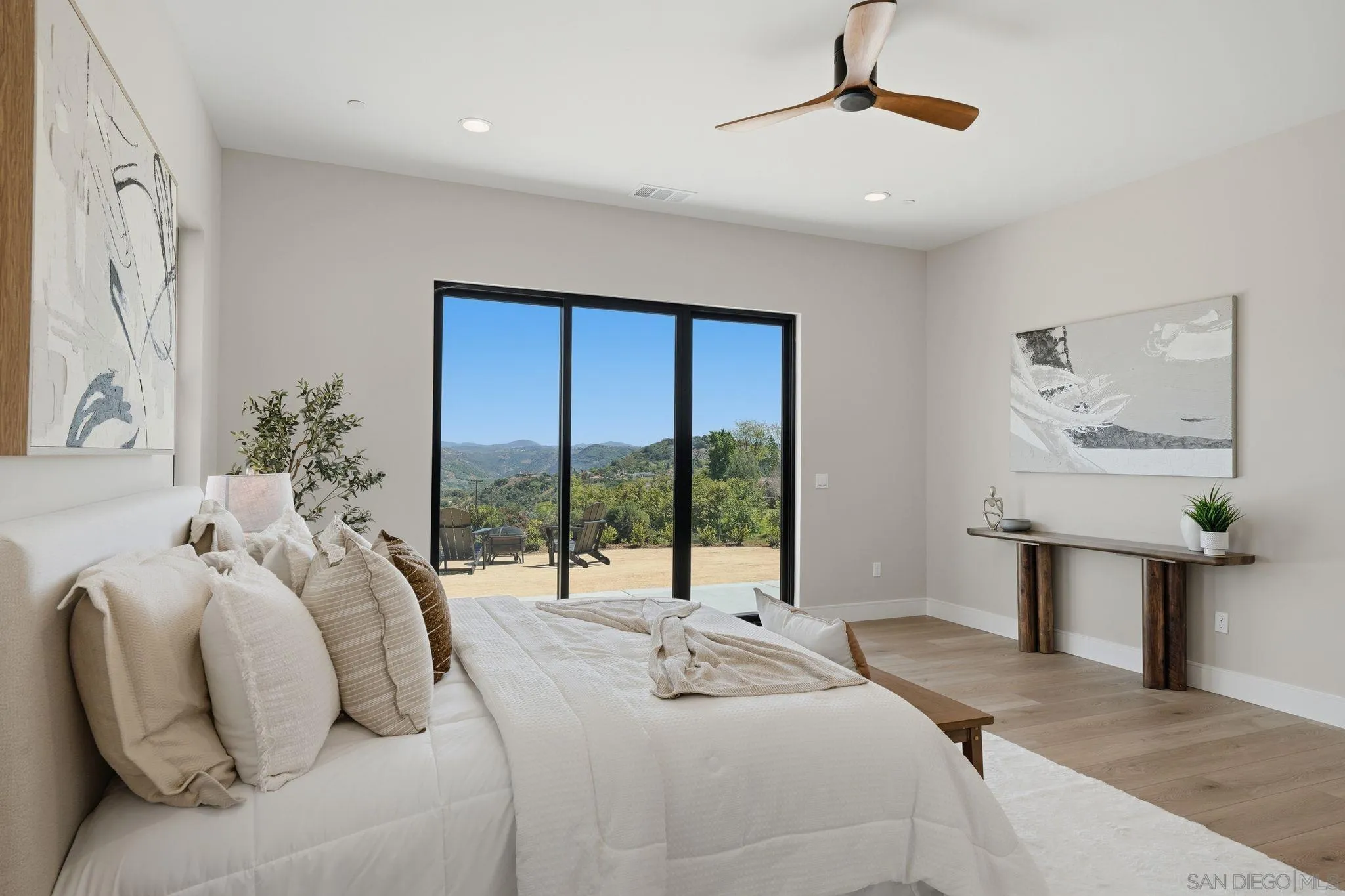 3916 Citrus Drive Fallbrook, CA 92028 - Photo 26 of 72 a bedroom with a balcony a bed and a chandelier